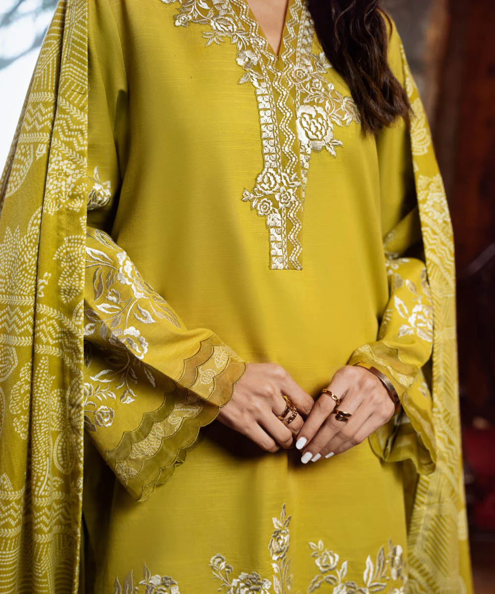 This is a Sapphire 3PEDY24DFV89 light khaddar 3-piece embroidered suit in yellow from the Signature Fall/Winter